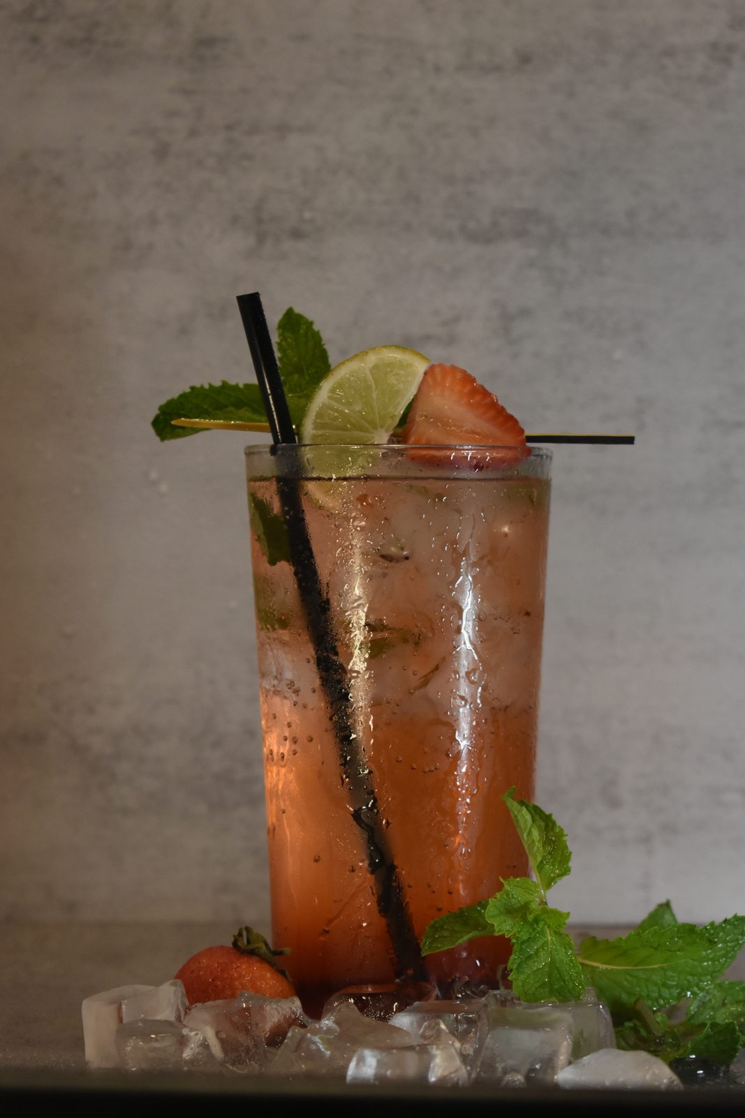 A BLOK 07 mocktail over ice with strawberry, lime and mint
